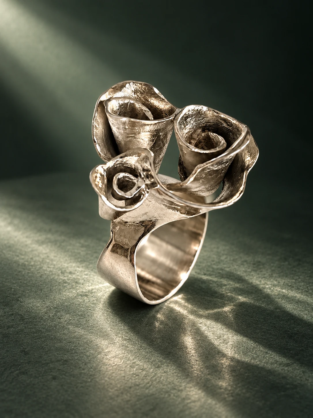 Handmade sculptural silver ring, abstract floral forms on green stone